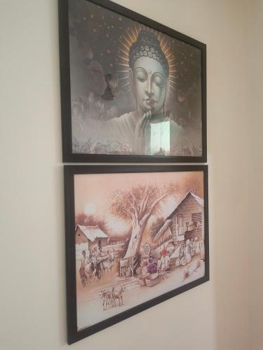 two framed pictures of a statue on a wall at Yb home in Sonīpat