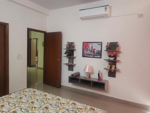 a bedroom with a bed and shelves on the wall at Yb home in Sonīpat