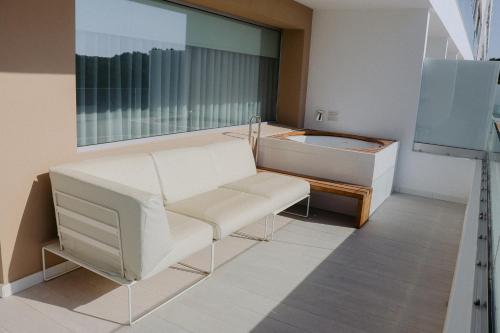 a room with a bath tub and a mirror at Hotel Cala Saona & Spa in Cala Saona