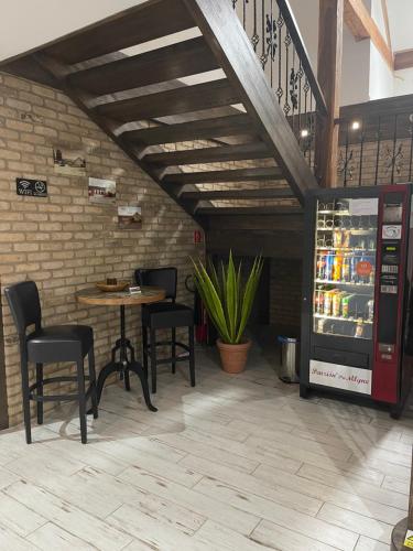 a restaurant with a table and chairs and a drink cooler at Penzión Pri Mlyne in Nitra