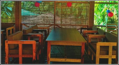 コックスバザールにあるAngel Resort & Restaurantのテーブルと椅子、窓が備わる客室です。