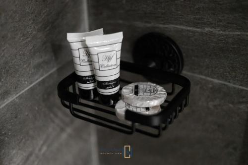 a shelf with two coffee cups and a watch at فندق جولدن نيو الصفا - Golden New Al Safa Hotel in Jeddah