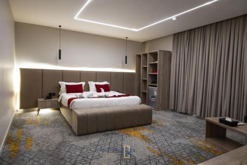 a bedroom with a large bed with red pillows at Golden New Al Safa in Jeddah