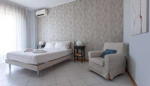 a bedroom with a bed and a chair at Italianway - Bergognone 47 in Milan