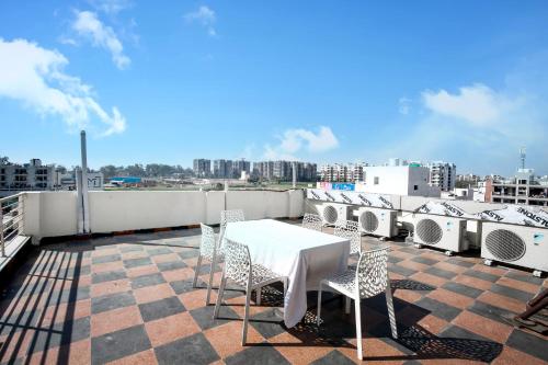 a table and chairs on the roof of a building at Hotel Woodcrest Zirakpur Chandigarh- Best Family Hotel in Chandīgarh