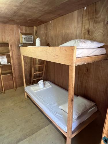 a couple of bunk beds in a room at Cabanas Pacifico Siargao Tourist Inn in San Isidro