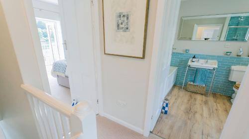 a small bathroom with a sink and a mirror at Noddfa in Menai Bridge