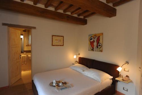 a bedroom with a bed with a tray of food on it at Villa Costa piccola with private pool in Umbria in Umbertide