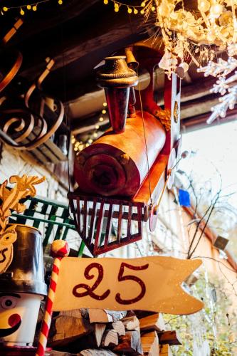 a close up of a clock on a wall with a sign at Au2 Maison d'Hôtes - Guest House Au2 in Muidorge