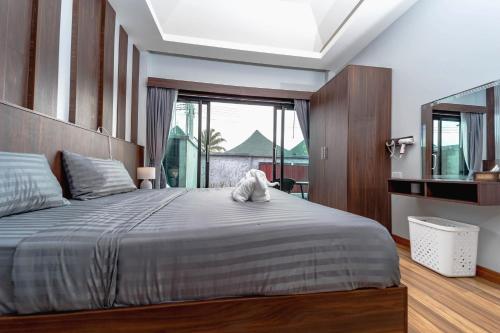 a bedroom with a bed with a stuffed animal on it at N&D Poolvilla in Ao Nang Beach