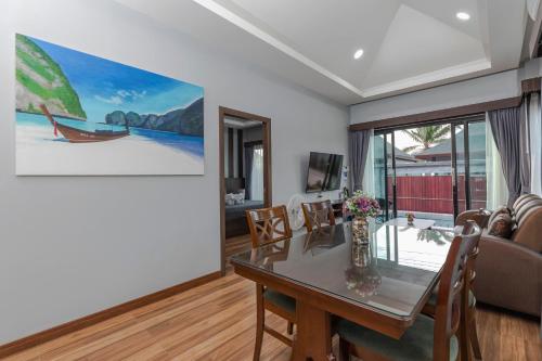 a living room with a table and a couch at N&D Poolvilla in Ao Nang Beach