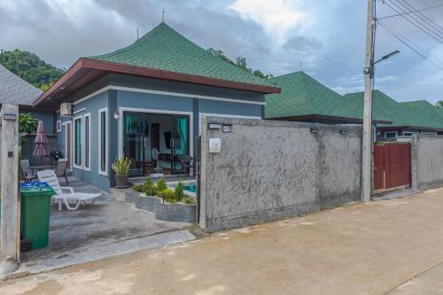 a house with a fence in front of it at N&D Poolvilla in Ao Nang Beach