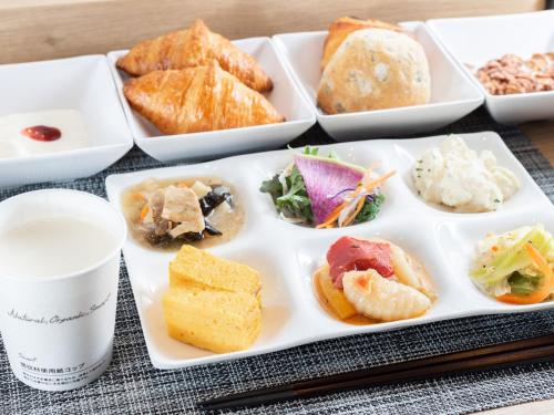a plate of different types of food on a table at Super Hotel Chiba Ekimae in Chiba