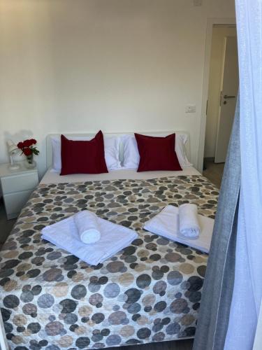 a bedroom with a large bed with towels on it at RESIDENZA GIOVANNI in Contone