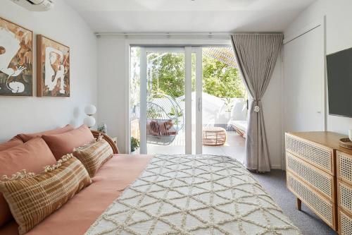 a bedroom with a bed and a sliding glass door at Canopy Terrace - Retreat to Voguish Urban Charm in Melbourne