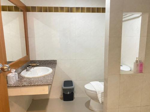 a bathroom with a sink and a toilet at President Hotel Udonthani in Udon Thani