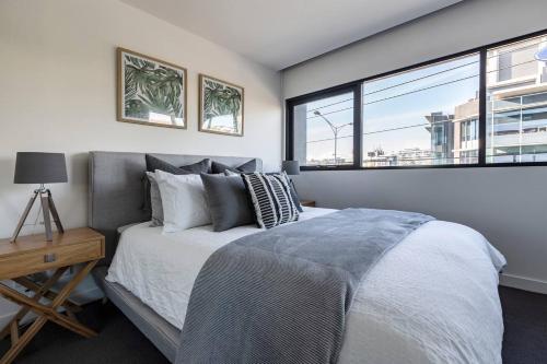 a bedroom with a large bed and a window at Stunning Modern Style with a Gym, Pool and Spa in Melbourne