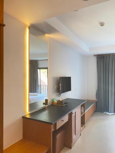 a hotel room with a large mirror in a room at President Hotel Udonthani in Udon Thani