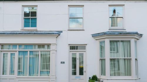 a white building with windows and a cross on top at The Hideaway Beaumaris in Beaumaris