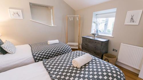a bedroom with two beds and a window at The Hideaway Beaumaris in Beaumaris
