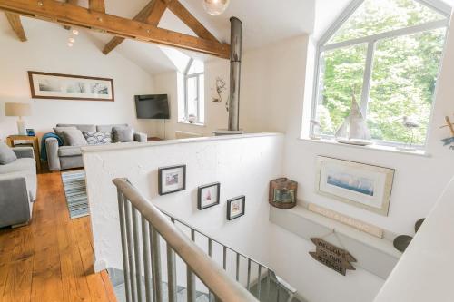 a living room with a staircase and a window at The Moorings in Menai Bridge