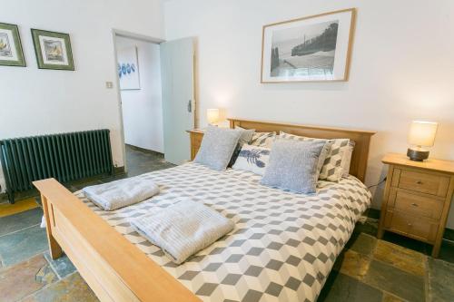 a bedroom with a large bed with pillows on it at The Moorings in Menai Bridge