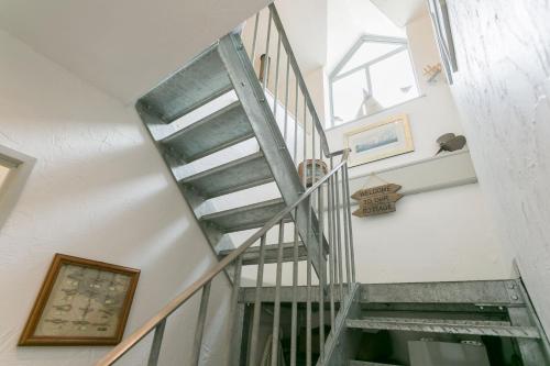 a spiral staircase in a house with a window at The Moorings in Menai Bridge