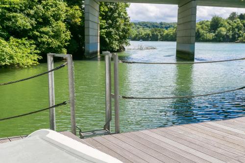 a bridge over a body of water with a dock at The Moorings in Menai Bridge
