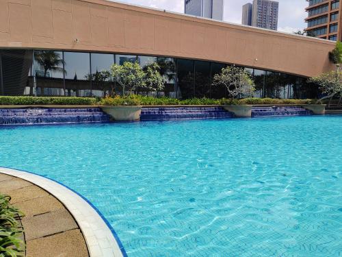 a large swimming pool in front of a building at Kl Continew Suite At Times Square in Kuala Lumpur