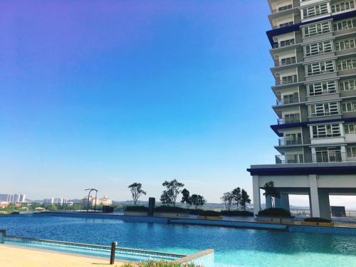 a large swimming pool next to a tall building at Palmyra Residence in Kajang