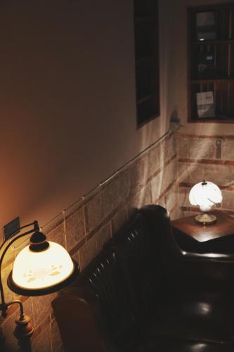 a waiting room with a bench and two lamps at 序室 Narrative in Jinhu