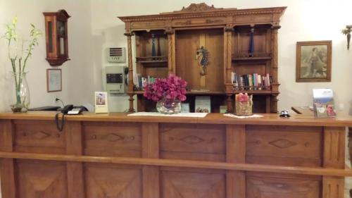 a large wooden cabinet with books on it at Ippokampos in Hydra