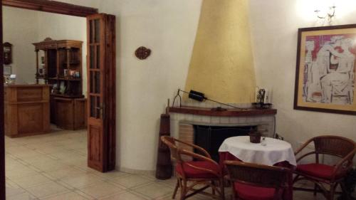 a living room with a table and a fireplace at Ippokampos in Hydra