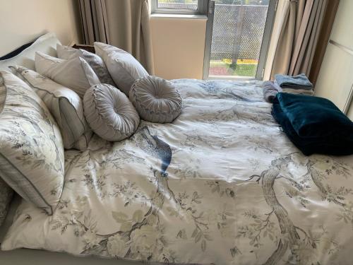 1 cama con almohadas y ventana en Executive Luxury 2 Bedroom Apartment - With underground parking en Londres