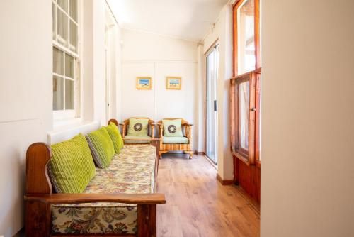 a living room with a couch and two chairs at De Rusty Farm in De Rust