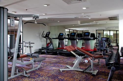 a gym with several treadmills and exercise bikes at AC Hotel by Marriott Kuantan in Kuantan