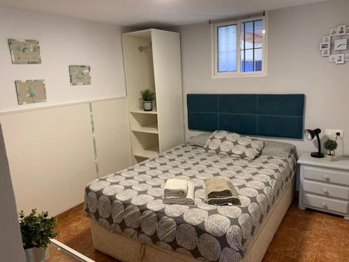 a bedroom with a bed with two shoes on it at Apartamento situado a 3minutos del PTA campanillas in Málaga
