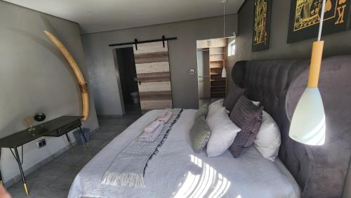 a bedroom with a large bed with pillows at Lloyds - 3 in Ermelo