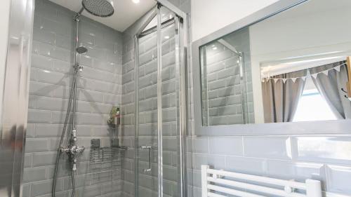 a bathroom with a shower and a mirror at Ty Coets in Llanfairpwllgwyngyll
