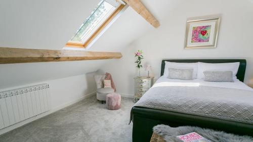 a bedroom with a bed and a window at Ty Coets in Llanfairpwllgwyngyll