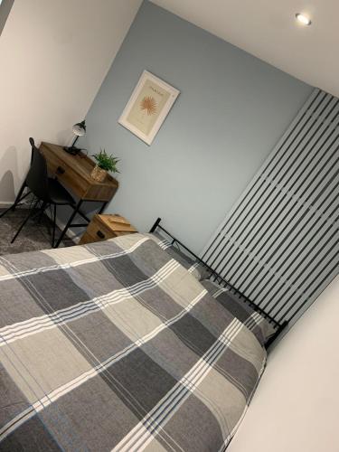a bedroom with a bed and a desk at Jesmond heart stays in Hartlepool