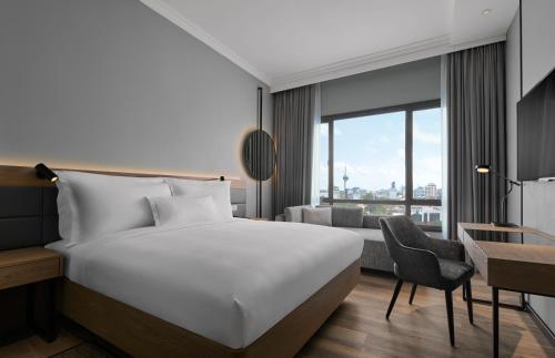a hotel room with a bed and a desk at AC Hotel by Marriott Kuantan in Kuantan