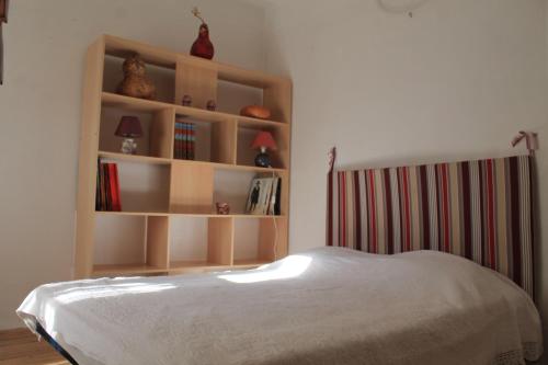 - une chambre avec un lit et une étagère dans l'établissement logement au sein d une abbaye cistercienne, à Saint-Martin-le-Vieil