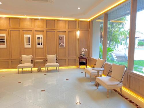 a waiting room with chairs and a table at President Hotel Udonthani in Udon Thani