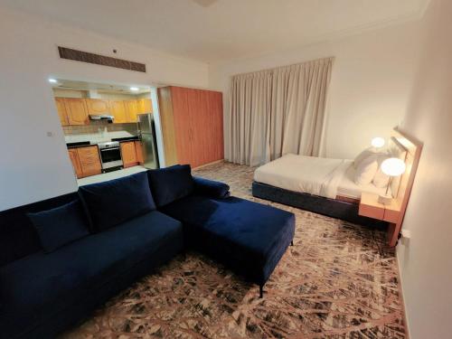 a hotel room with a couch and a bed at Havana Holiday Homes Oud Metha in Dubai