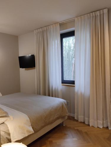 a bedroom with a bed and a window at La Morra 66 in La Morra