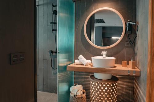 a bathroom with a sink and a mirror at Poem Suites by Airnest in Las Palmas de Gran Canaria