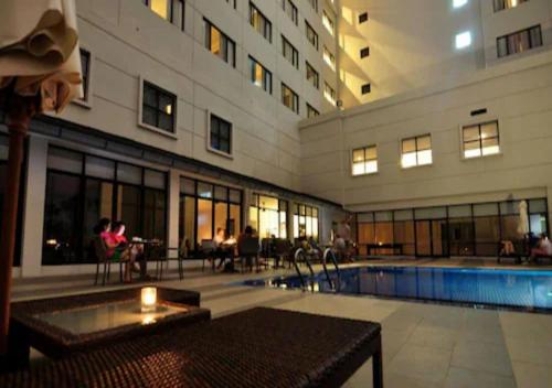 a large building with a swimming pool in a building at AC Hotel by Marriott Kuantan in Kuantan