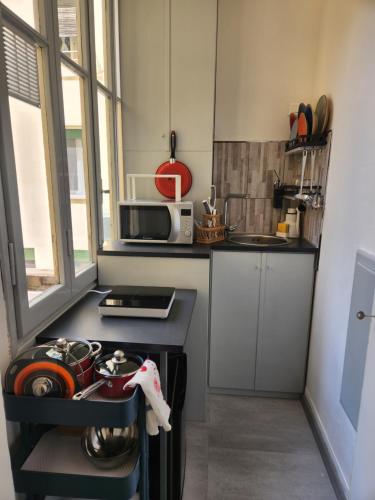 a small kitchen with a stove and a microwave at Soggiorno La Coccinella in Florence