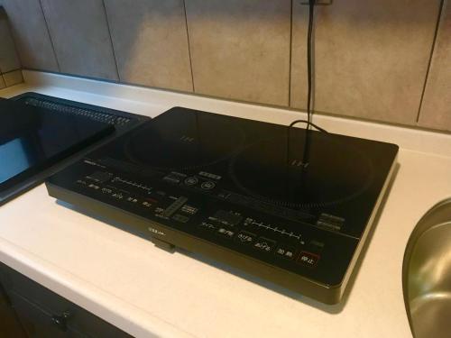 a black mixing console sitting on top of a counter at NOW TRAVEL ShinOsaka in Osaka